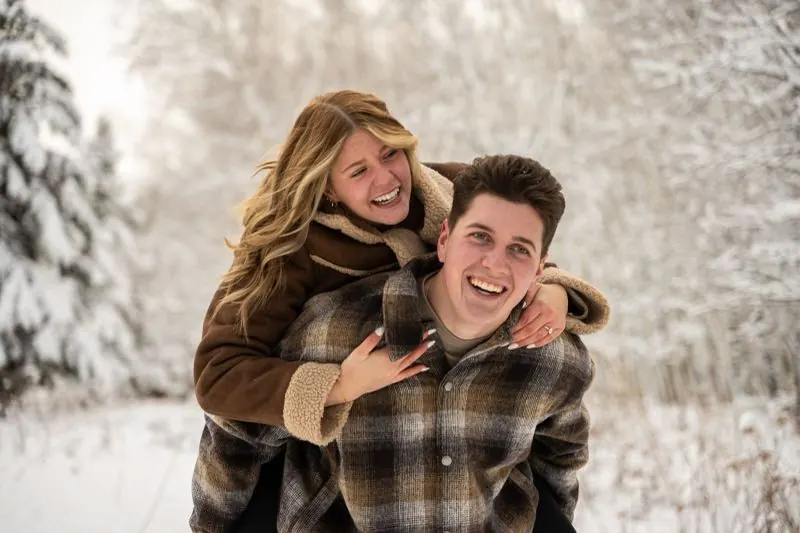 Piggyback ride through a snowy forest